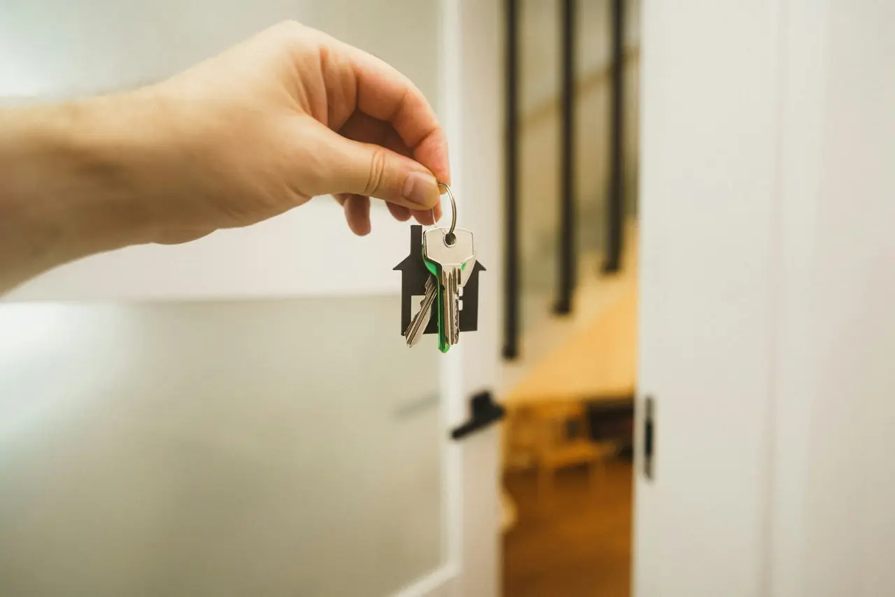 House keys handed over at the door of a home
